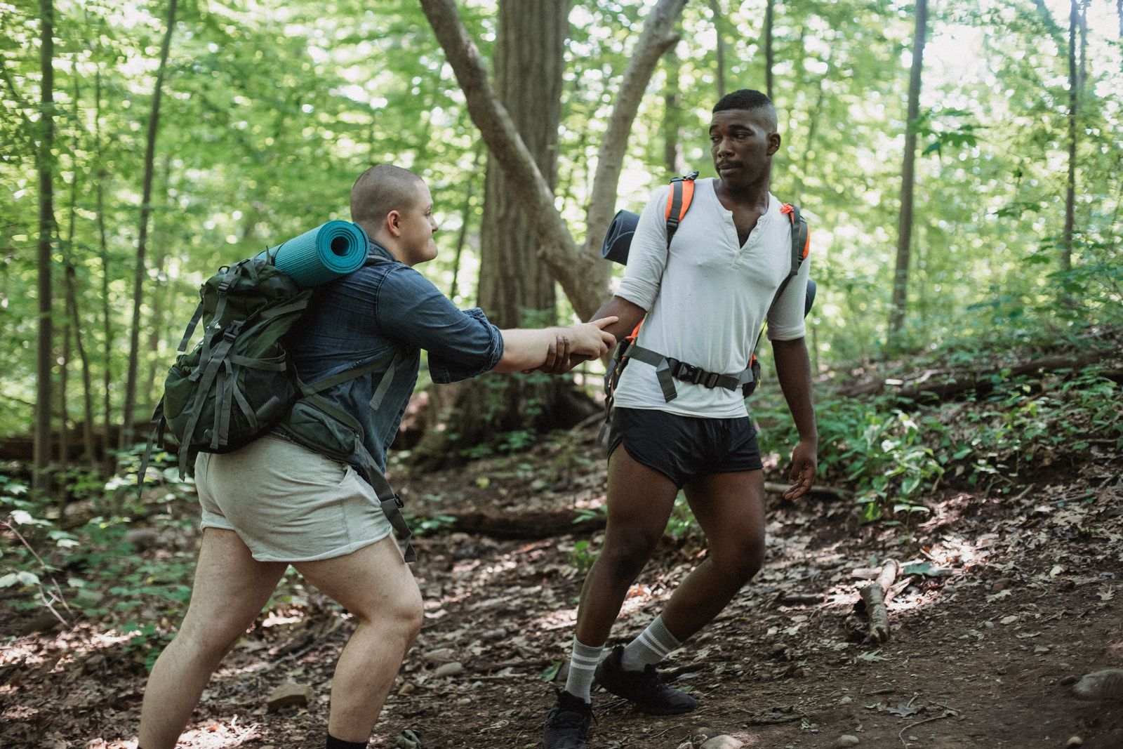 Friends supporting each other on an outdoor adventure